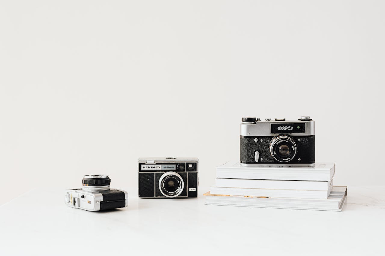 Three vintage cameras displayed on a white background, emphasizing nostalgia and retro design.